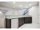 Basement bar area with granite countertops, dark cabinets, and mini fridge at 2264 S Joyce St, Lakewood, CO 80228