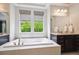 Stylish bathroom featuring a soaking tub, dual sinks, and modern fixtures at 2264 S Joyce St, Lakewood, CO 80228