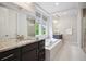 Luxurious primary bathroom with a soaking tub, double vanities, and a separate shower at 2264 S Joyce St, Lakewood, CO 80228