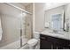 Bathroom with glass enclosed shower, granite countertops, and dark wood cabinets at 2264 S Joyce St, Lakewood, CO 80228