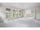 Bright bedroom with soft carpet, french doors, and ample natural light from large windows at 2264 S Joyce St, Lakewood, CO 80228