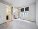 Spacious bedroom with large windows, plush carpeting, and an adjoining bathroom at 2264 S Joyce St, Lakewood, CO 80228
