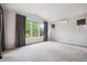 Bright and airy bedroom with large windows offering views of the outdoor landscape at 2264 S Joyce St, Lakewood, CO 80228