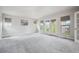 Spacious bedroom with plush carpet, large windows, and French doors leading to a balcony at 2264 S Joyce St, Lakewood, CO 80228