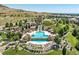 Aerial view of the community pool and amenities surrounded by lush landscaping at 2264 S Joyce St, Lakewood, CO 80228