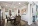 Elegant dining room with coffered ceiling, stylish decor, and ample natural light at 2264 S Joyce St, Lakewood, CO 80228