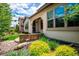 Charming home exterior features a stone accent wall and beautifully landscaped front yard at 2264 S Joyce St, Lakewood, CO 80228
