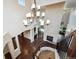 Grand foyer showcasing a stone fireplace, hardwood floors, and an elegant chandelier at 2264 S Joyce St, Lakewood, CO 80228