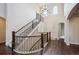 Elegant two-story foyer with a curved staircase, hardwood floors, and a stylish chandelier at 2264 S Joyce St, Lakewood, CO 80228