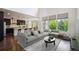 Bright living room with high ceilings, many windows, and an expansive grey sectional at 2264 S Joyce St, Lakewood, CO 80228