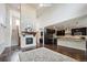 Open concept living space featuring a fireplace and modern kitchen at 2264 S Joyce St, Lakewood, CO 80228
