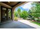 Covered patio with archways looking out on lush landscaping and the fenced backyard at 2264 S Joyce St, Lakewood, CO 80228