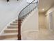 Carpeted staircase with dark wood railing, leading to the upper level, next to finished basement at 2264 S Joyce St, Lakewood, CO 80228