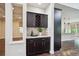 Stylish wet bar with granite countertop, wine rack, and custom cabinets for entertaining guests at 2264 S Joyce St, Lakewood, CO 80228