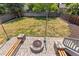 Spacious backyard featuring a fire pit area with custom benches and wood fencing at 9917 Garland Dr, Broomfield, CO 80021