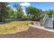 Large backyard area with a charming fire pit, wooden benches, and a grassy area for recreation at 9917 Garland Dr, Broomfield, CO 80021