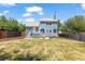 View of the backyard highlighting the patio area, fire pit, and well-maintained lawn at 9917 Garland Dr, Broomfield, CO 80021
