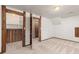 Basement rec room with exposed wood columns, closet space, and doorway, blending rustic charm with practical design at 9917 Garland Dr, Broomfield, CO 80021