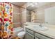 Bathroom with colorful shower curtain, vanity with modern sink, and tiled shower, offering both style and functionality at 9917 Garland Dr, Broomfield, CO 80021