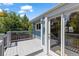 Inviting deck with stylish gray wood, white trim, access door and an attractive outdoor light fixture at 9917 Garland Dr, Broomfield, CO 80021