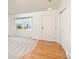 Bright entryway featuring hardwood floors, fresh carpet, and a coat closet at 9917 Garland Dr, Broomfield, CO 80021