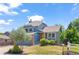 Charming blue two-story home featuring a well-manicured lawn, brick accents, and a lovely garden with mature landscaping at 9917 Garland Dr, Broomfield, CO 80021