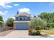 Traditional two-story home with a blue exterior, brick details, and a well-maintained lawn with mature landscaping at 9917 Garland Dr, Broomfield, CO 80021
