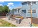 Relaxing outdoor patio with built-in benches, brick pavers, and a cozy stone fire pit feature at 9917 Garland Dr, Broomfield, CO 80021