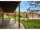 View of a spacious backyard with a patio, detached garage, and cozy fire pit at 30221 Stagecoach Blvd, Evergreen, CO 80439