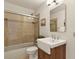 Bright bathroom with a white sink and a glass enclosed shower and bathtub combo at 30221 Stagecoach Blvd, Evergreen, CO 80439