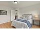 Bedroom with an iron bed frame, wood-look floors and an adjacent doorway at 30221 Stagecoach Blvd, Evergreen, CO 80439