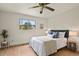Bedroom with wood-look flooring and a large window offering an exterior view at 30221 Stagecoach Blvd, Evergreen, CO 80439