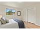 Bedroom with wood-look floors, closet, and a large window offering an exterior view at 30221 Stagecoach Blvd, Evergreen, CO 80439