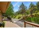 Inviting deck space that overlooks the serene surrounding landscape and tree coverage at 30221 Stagecoach Blvd, Evergreen, CO 80439