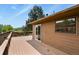 Back deck features a sliding glass door to the home at 30221 Stagecoach Blvd, Evergreen, CO 80439