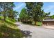Scenic view of home's driveway, two car detached garage and a cozy deck at 30221 Stagecoach Blvd, Evergreen, CO 80439
