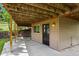 Exterior shot of the home with a covered patio area and a stone wall feature at 30221 Stagecoach Blvd, Evergreen, CO 80439