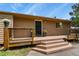Welcoming front porch with wooden steps and stylish black door, perfect for curb appeal at 30221 Stagecoach Blvd, Evergreen, CO 80439