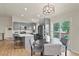 Bright kitchen with gray cabinets, island seating and dining table next to a sliding glass door to the patio at 30221 Stagecoach Blvd, Evergreen, CO 80439