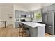 Modern kitchen featuring gray cabinets, stainless steel appliances, and an island at 30221 Stagecoach Blvd, Evergreen, CO 80439