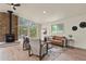 Bright living area featuring a stone fireplace and hardwood flooring at 30221 Stagecoach Blvd, Evergreen, CO 80439