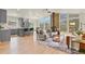 Open-concept living room featuring a stone fireplace and large windows at 30221 Stagecoach Blvd, Evergreen, CO 80439