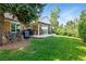 Spacious backyard boasting a covered patio with outdoor seating and a lush green lawn at 6979 E Fremont Ave, Centennial, CO 80112