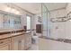 Elegant bathroom with marble countertops, a walk-in shower, and modern fixtures at 6979 E Fremont Ave, Centennial, CO 80112