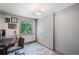 Bedroom with hardwood floors and a guitar next to a bright window at 6979 E Fremont Ave, Centennial, CO 80112