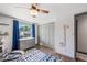 Bright bedroom featuring a ceiling fan, blue rug, and a growth chart at 6979 E Fremont Ave, Centennial, CO 80112