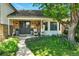 Inviting front porch with chairs and beautiful landscaping, enhancing the home's curb appeal at 6979 E Fremont Ave, Centennial, CO 80112