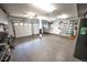 Spacious two car garage featuring durable epoxy flooring, bright lighting and plenty of wall-mounted storage systems at 6979 E Fremont Ave, Centennial, CO 80112