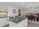 Bright kitchen features a granite island, white cabinets, and a built-in wine rack at 6979 E Fremont Ave, Centennial, CO 80112