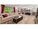 Open living room with large windows and exposed ceiling beams exudes comfort and style at 6979 E Fremont Ave, Centennial, CO 80112